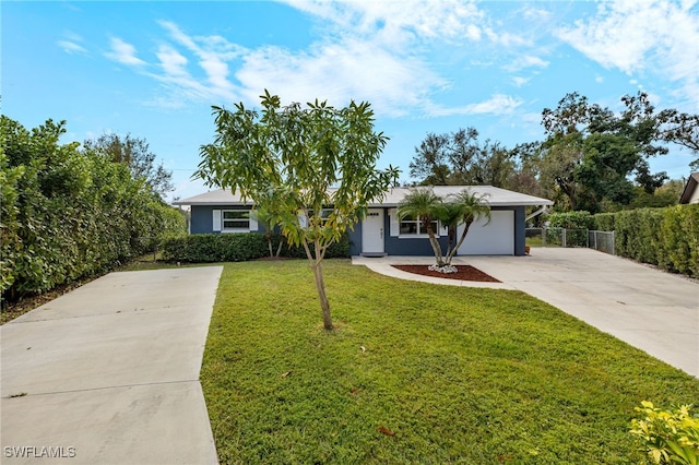 single story home featuring a garage and a front lawn