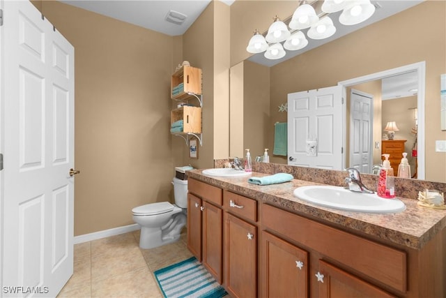 bathroom featuring tile patterned flooring, vanity, and toilet