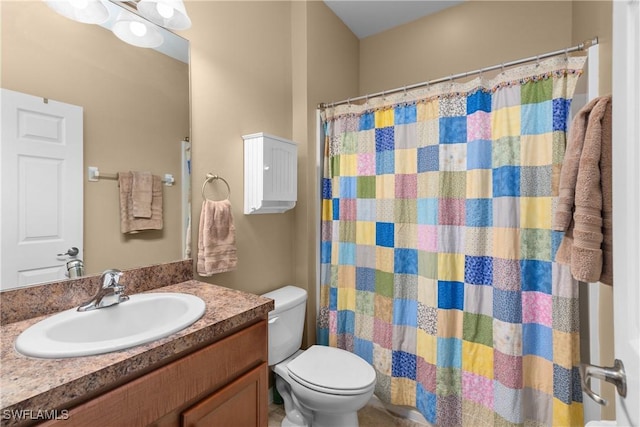 bathroom with vanity, toilet, and walk in shower