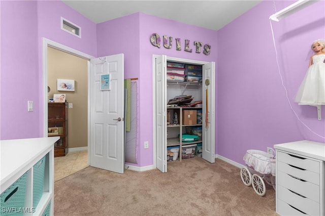 bedroom with light colored carpet and a closet