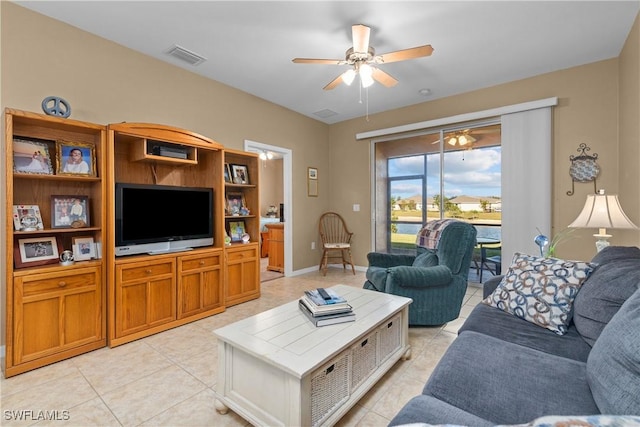 tiled living room featuring ceiling fan