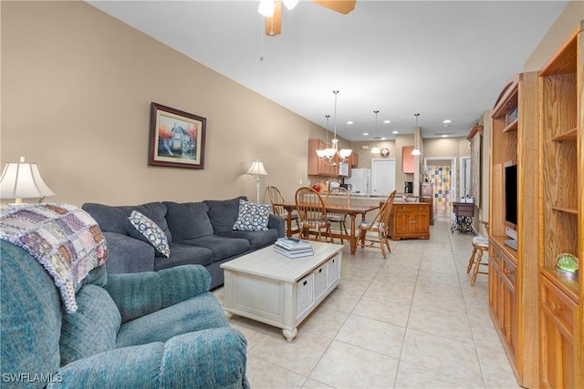 living room with ceiling fan with notable chandelier and light tile patterned floors