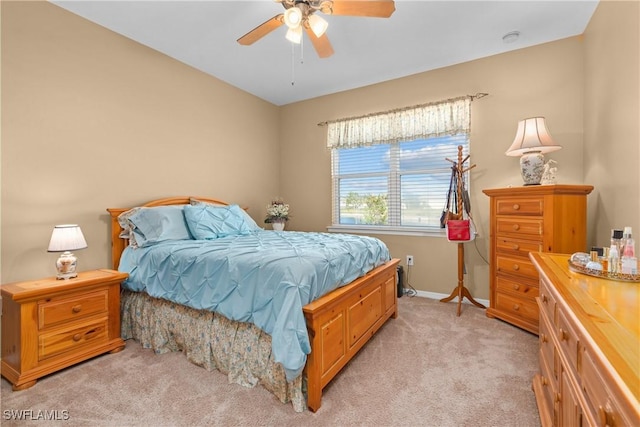 bedroom featuring ceiling fan and light carpet