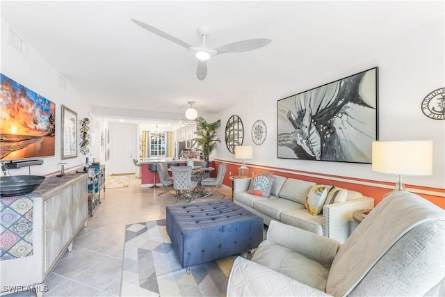 living room featuring ceiling fan and light tile patterned floors