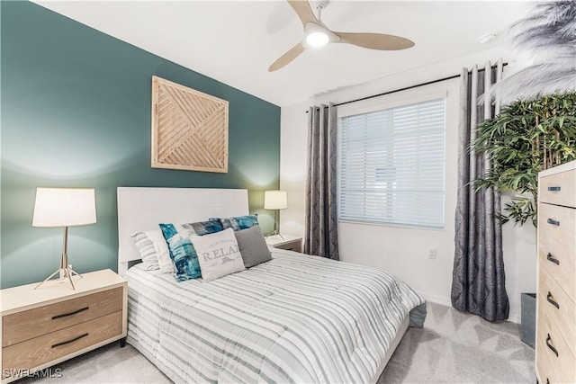 bedroom featuring ceiling fan and light colored carpet