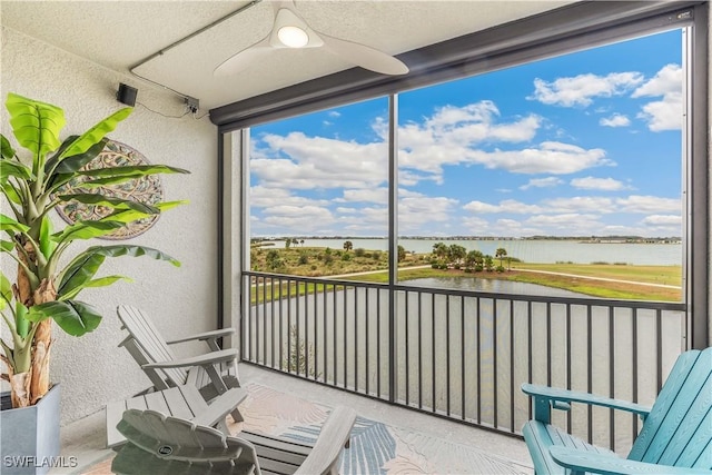 sunroom / solarium featuring a water view