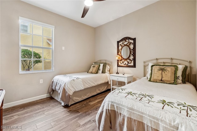 bedroom with wood-type flooring and ceiling fan