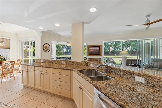 kitchen with light tile patterned floors, stone countertops, ceiling fan, and sink