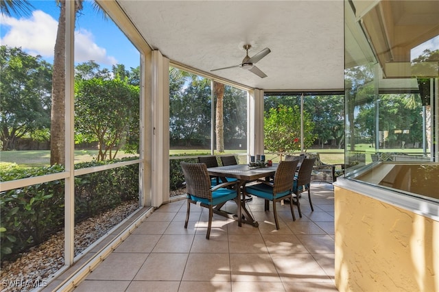 sunroom featuring a ceiling fan and a wealth of natural light