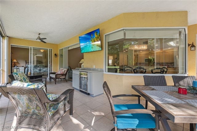 view of patio / terrace featuring a ceiling fan, outdoor dining area, beverage cooler, and an outdoor hangout area