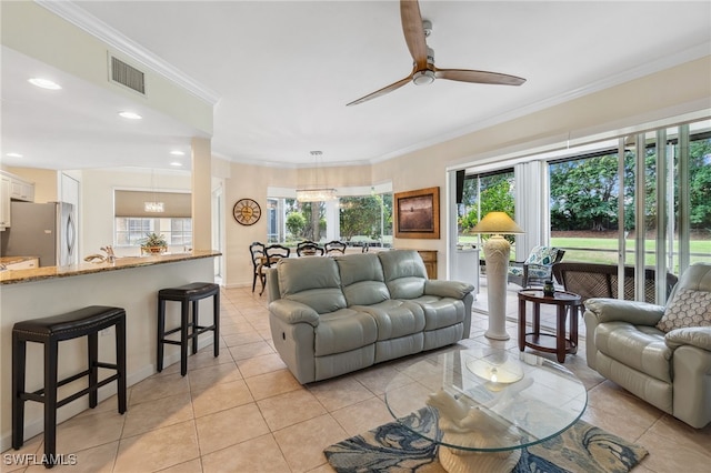 living room featuring ceiling fan, light tile patterned flooring, ornamental molding, and sink