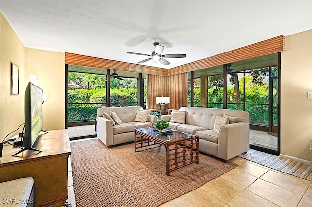 living area with a ceiling fan, a healthy amount of sunlight, and light tile patterned flooring