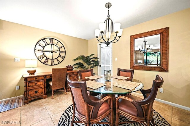 dining space with light tile patterned flooring and a notable chandelier