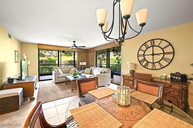 dining room with ceiling fan with notable chandelier and light tile patterned floors