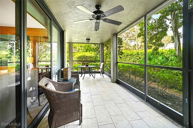 sunroom / solarium featuring ceiling fan