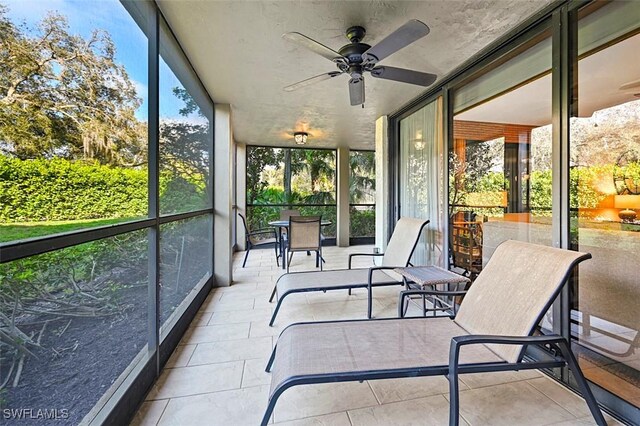 sunroom / solarium featuring ceiling fan