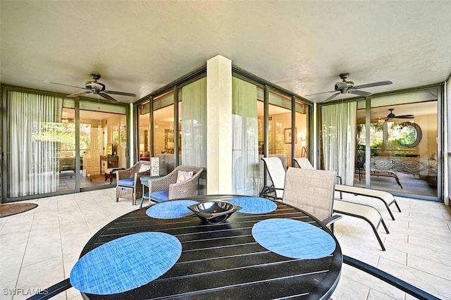 sunroom / solarium featuring ceiling fan