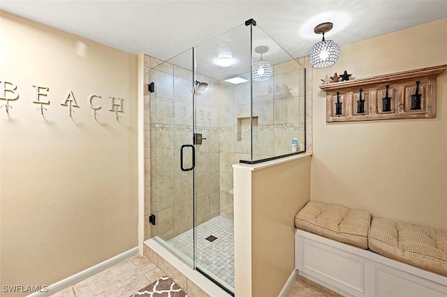 bathroom with tile patterned flooring and a shower with shower door