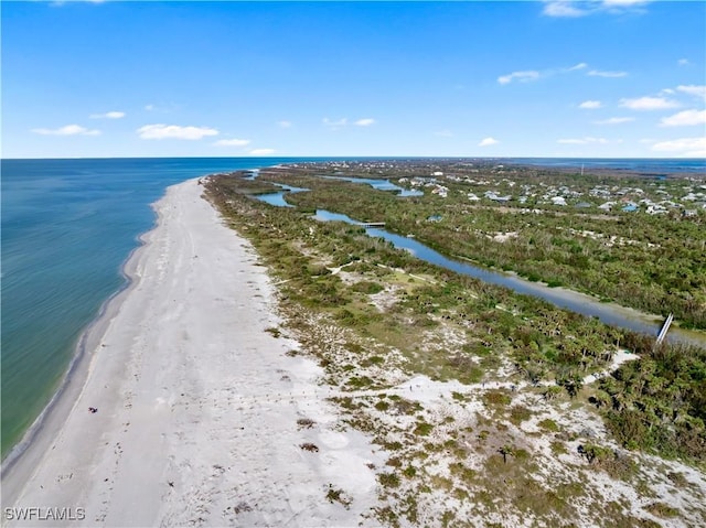 drone / aerial view featuring a beach view and a water view