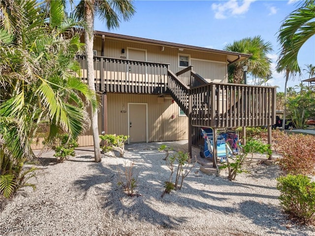 back of house with a wooden deck