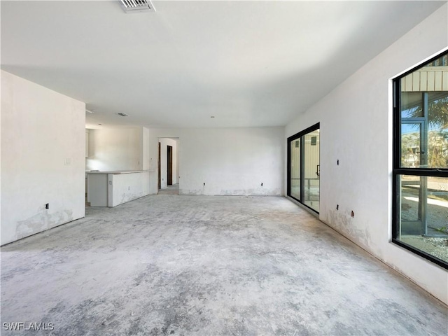 unfurnished room featuring plenty of natural light