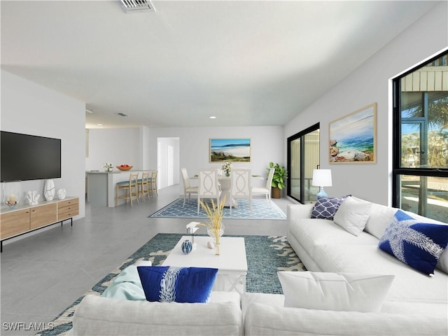 living room featuring concrete flooring