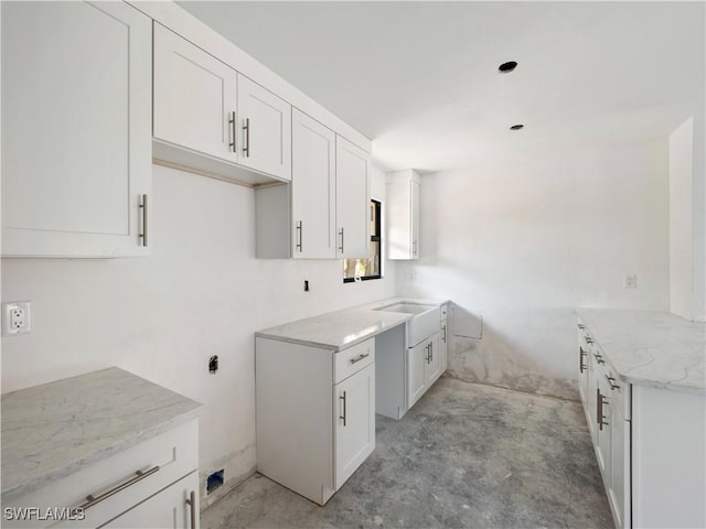 kitchen with white cabinets and light stone countertops