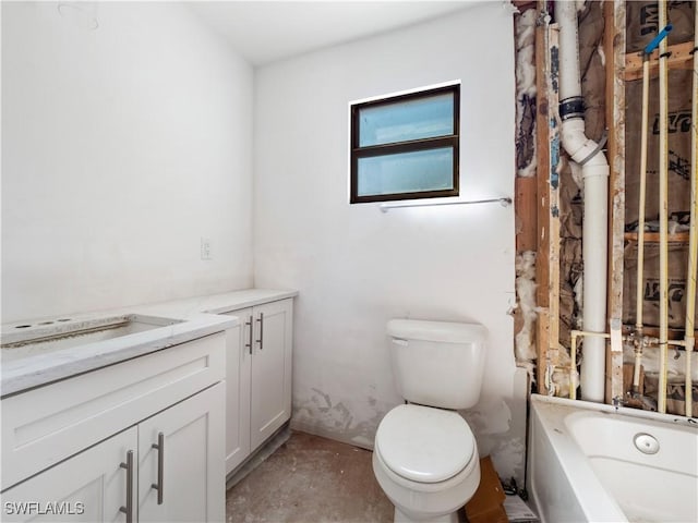 bathroom featuring a bathtub, toilet, and vanity