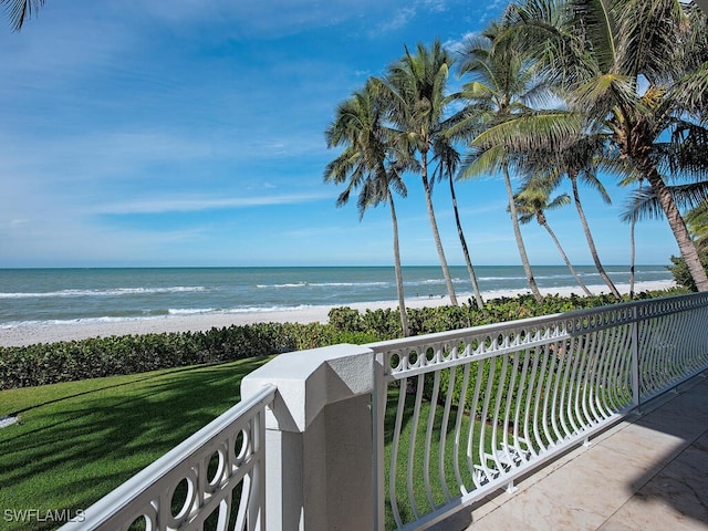 balcony with a water view and a beach view