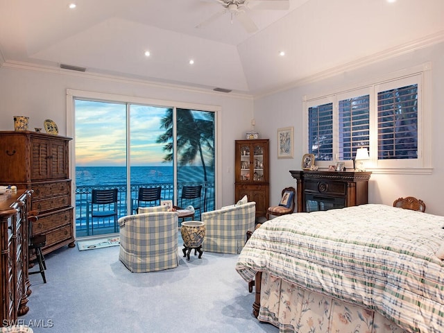 carpeted bedroom featuring ceiling fan, lofted ceiling, a tray ceiling, a water view, and access to outside