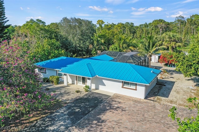 view of swimming pool featuring a lanai