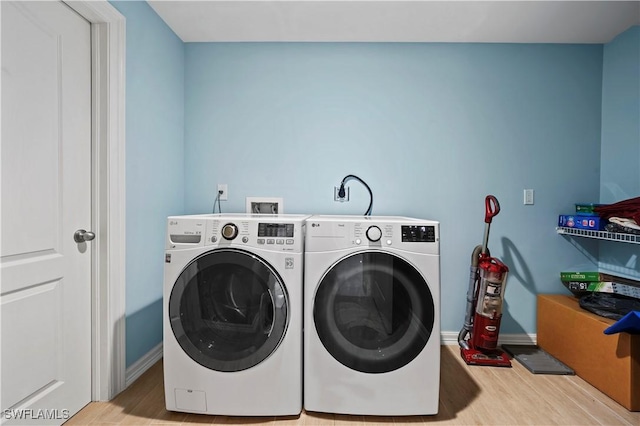 laundry area featuring separate washer and dryer and light wood-type flooring