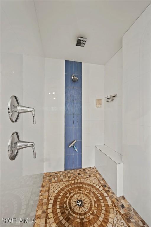 bathroom with a tile shower