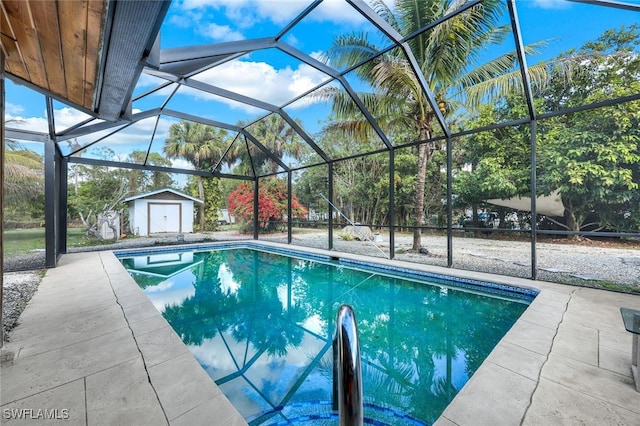 view of swimming pool with a storage shed, a lanai, and a patio area