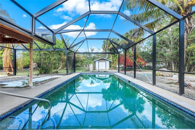 view of swimming pool with a storage shed, a lanai, and a patio area