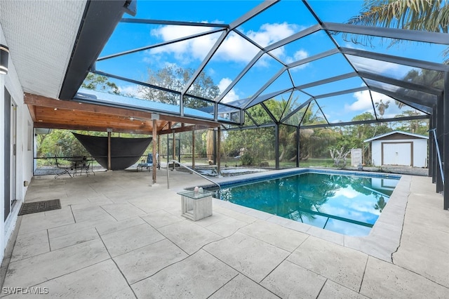 view of pool with a storage shed, a lanai, and a patio