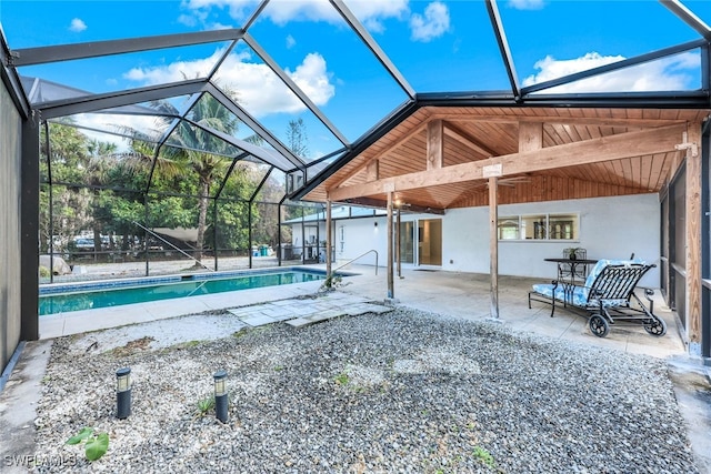 view of swimming pool with glass enclosure and a patio area