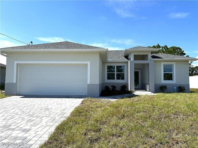 view of front of property featuring a front yard and a garage