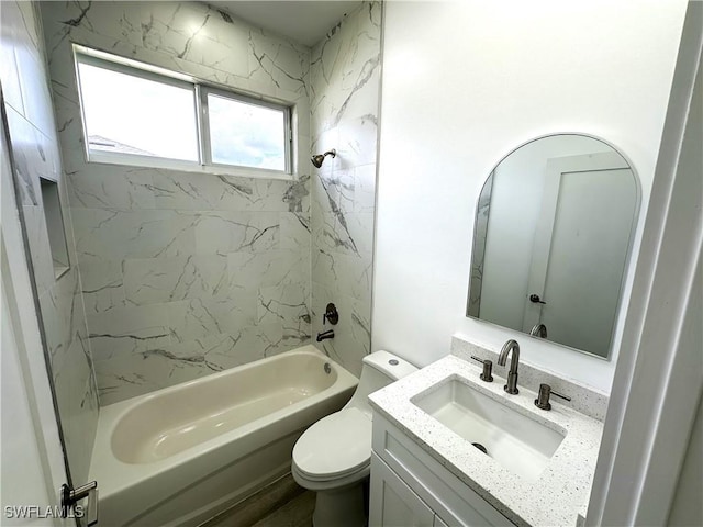 full bathroom featuring tiled shower / bath combo, toilet, and vanity