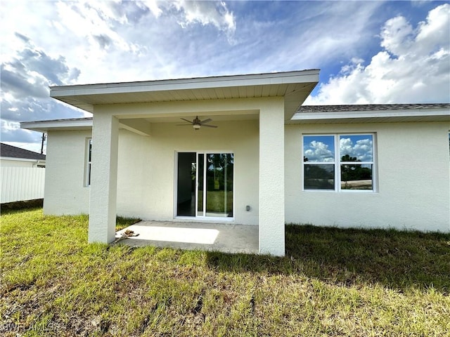 rear view of house with a lawn, ceiling fan, and a patio