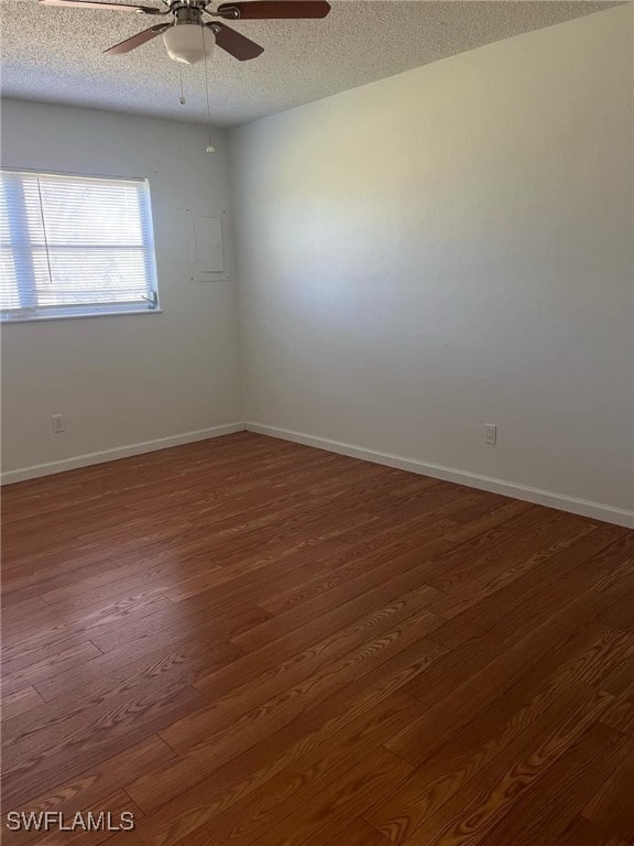 unfurnished room with ceiling fan, dark hardwood / wood-style floors, and a textured ceiling