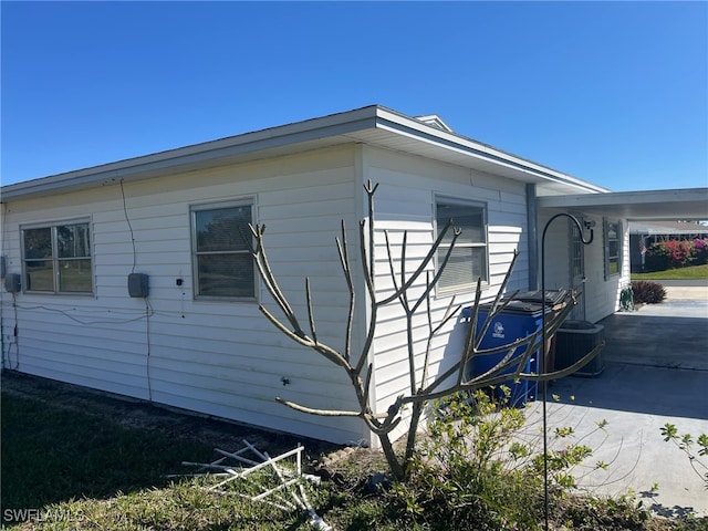 view of property exterior with a patio area