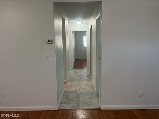 corridor with a textured ceiling