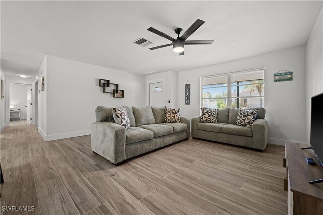 living room featuring ceiling fan and light wood-type flooring