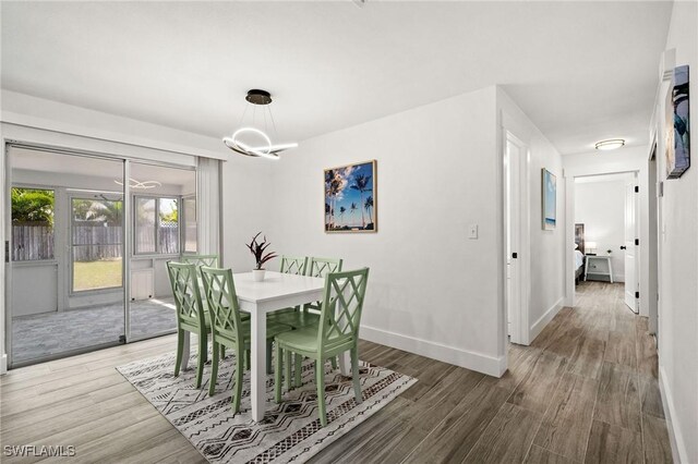 dining room featuring hardwood / wood-style flooring and an inviting chandelier