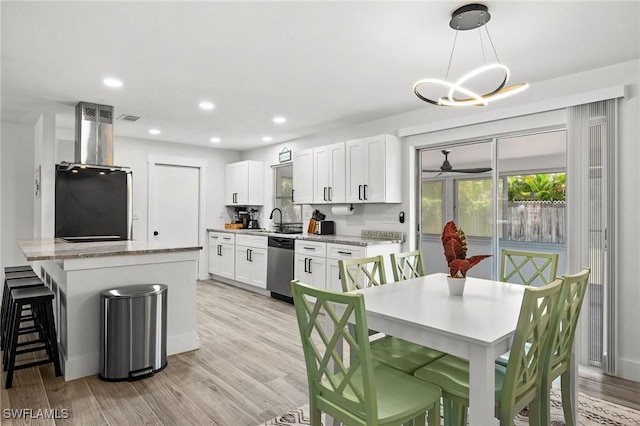 kitchen with black refrigerator, white cabinetry, dishwasher, and decorative light fixtures