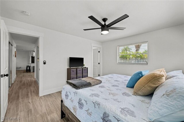 bedroom with light wood-type flooring and ceiling fan