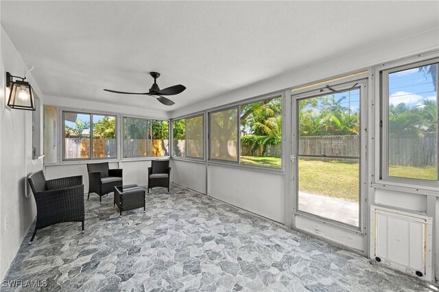 sunroom / solarium with ceiling fan and a wealth of natural light