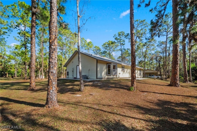 view of side of property with a lawn