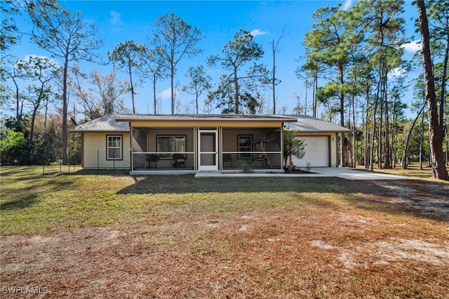 view of front of house with a garage, a front yard, and a sunroom